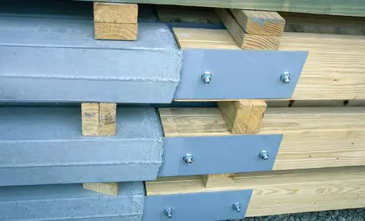 Perma-Column precast concrete lowers with steel brackets bolted to laminated wood columns
