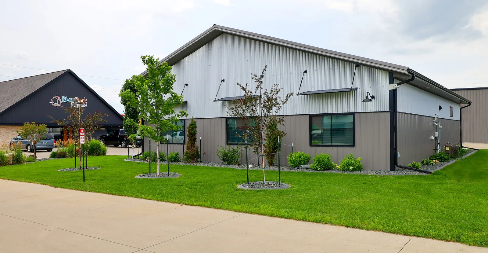 Large post-frame farm shop with multiple overhead doors on a flat prairie site
